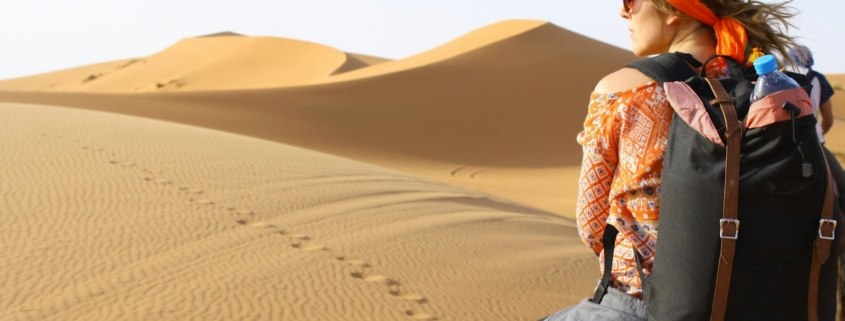 woman riding animal on dessert